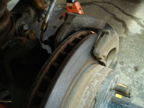 1996 Ford Bronco - Close-up view of a vehicle's brake rotor and caliper system.