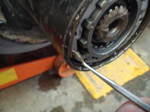1996 Ford Bronco - Close-up of a vehicle's hub assembly with a pick tool inspecting the splines.