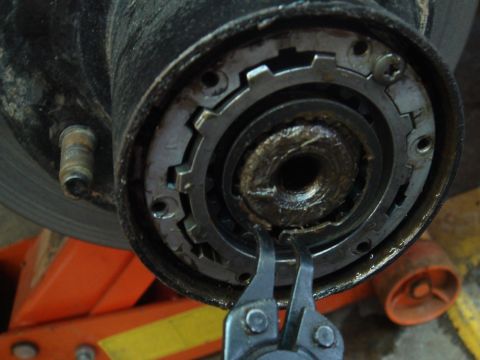 1996 Ford Bronco - A tool is used to manipulate the locking mechanism on a vehicle's wheel hub assembly.