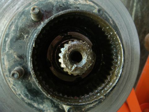 1996 Ford Bronco - A detailed view of a vehicle's wheel hub assembly, showing internal gears and grease.