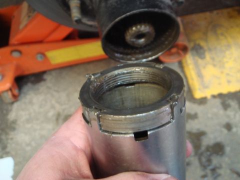 1996 Ford Bronco - A close-up view of a disassembled vehicle part, showing threaded components.
