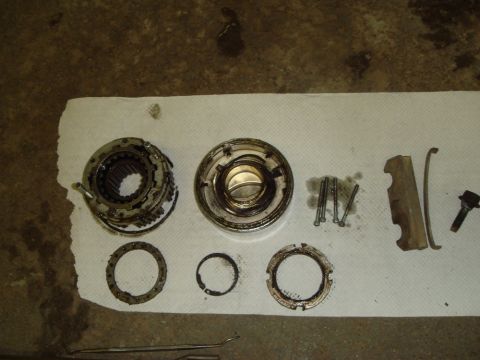 1996 Ford Bronco - Disassembled transmission components, including gears and fasteners, are laid out on a paper towel.