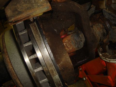 1996 Ford Bronco - Close-up view of a vehicle's brake rotor and suspension components, with a U-joint visible.