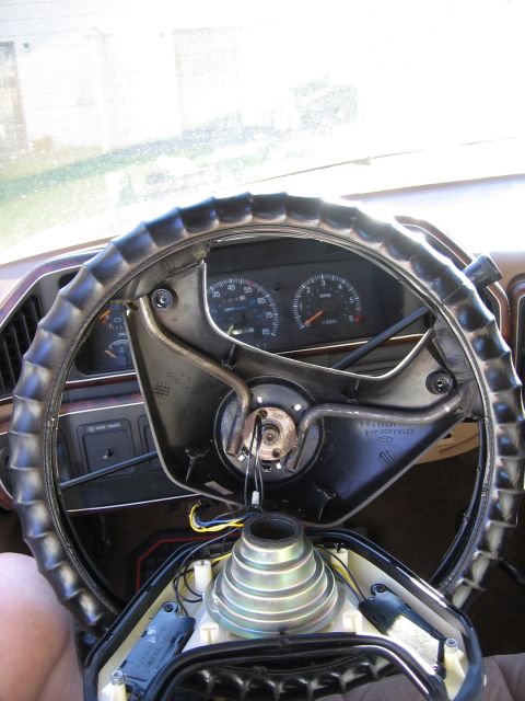1987 Ford Bronco - Interior view of a 1987 Ford Bronco with the steering column disassembled, revealing the dashboard.