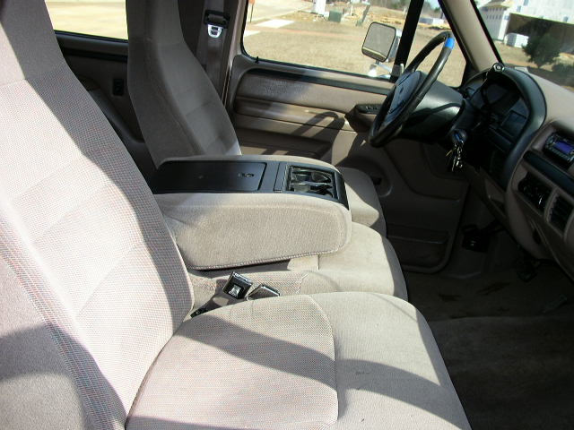 Interior view of a 1995 Ford Bronco showing front seats and dashboard