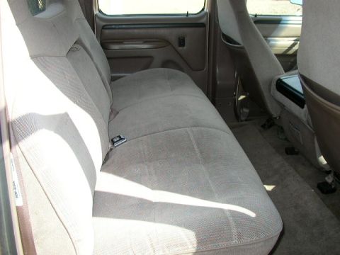 1995 Ford Bronco - Interior view of a 1995 Ford Bronco, showing the rear seating area and door trim.