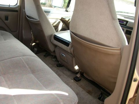 1995 Ford Bronco - Interior view of a 1995 Ford Bronco, showing the front seats and center console.