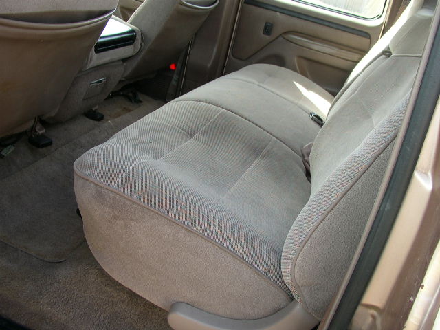 Tan fabric rear seat and center console in a vehicle