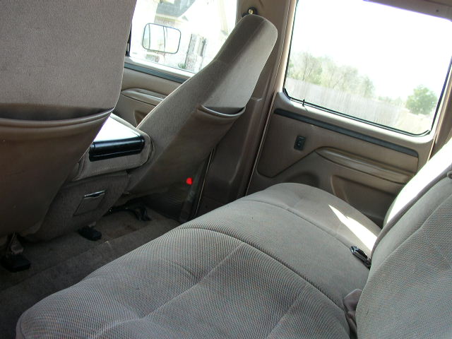 Interior view of a truck's rear seats and center console