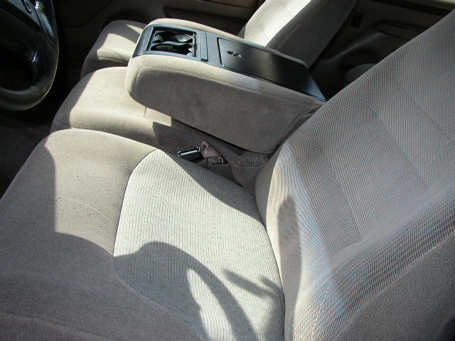 Interior view of car seats and center console. The album claims 1995 Ford Bronco, but this is not verifiable from the image