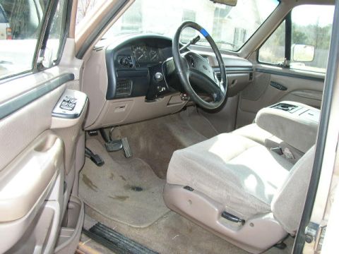1995 Ford Bronco - Interior view of a 1995 Ford Bronco, highlighting the dashboard, steering wheel, and seating area.