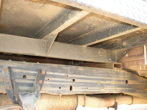 1995 Ford Bronco - The underside of a truck's frame and exhaust system is shown, with a Supermotors logo in the lower right corner.