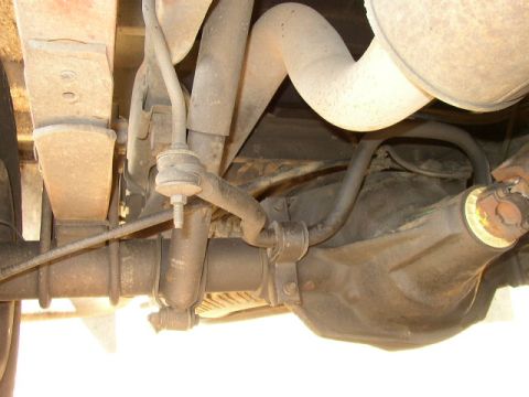 1995 Ford Bronco - Close-up of the rear axle and suspension system of a vehicle.