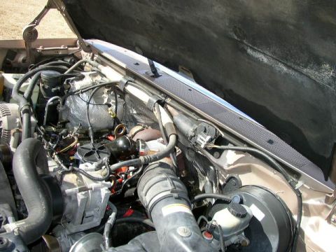 1995 Ford Bronco - Engine bay of a 1995 Ford Bronco, viewed from above with the hood raised.