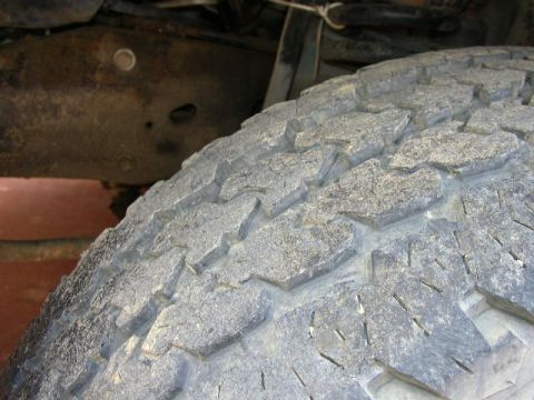 1995 Ford Bronco - Close-up view of a truck's tire and frame, with a Supermotors.net logo in the corner.