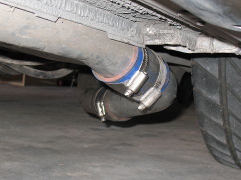 2001 Pontiac Trans Am - Underbody view shows exhaust piping secured with hose clamps, near a tire.