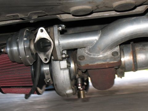 2001 Pontiac Trans Am - Underside view of a vehicle's turbocharger and exhaust system, a red air filter.