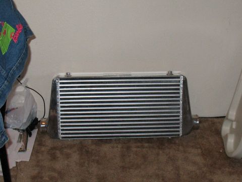 2001 Pontiac Trans Am - An intercooler part is shown resting on the floor.
