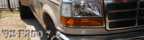 1992 Ford F-350 - Close-up of the front corner of a 1992 Ford F-350, highlighting the grille and headlight assembly.