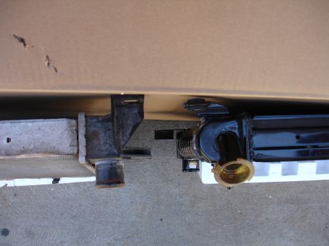 1992 Ford F-350 - Close-up view of two vehicle radiators, one appears to be aluminum and the other black metal with a brass connection.
