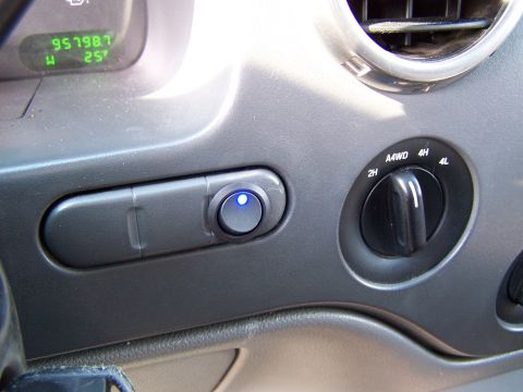 2004 Ford Expedition - Interior view of a 2004 Ford Expedition dashboard with 4WD controls and an active auxiliary switch.