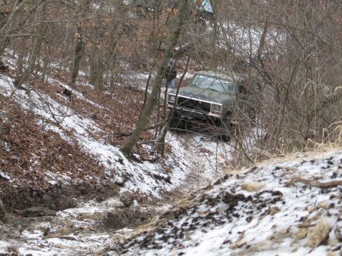 1995 Ford Bronco - A Ford Bronco navigates a snowy, wooded trail.