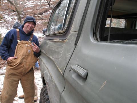 1995 Ford Bronco - A man poses next to a vintage green SUV in a wooded area with snow on the ground.