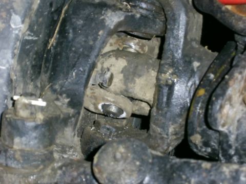 1978 Ford Bronco - This image shows a close-up view of the vehicle's suspension system, covered in dirt and grime.