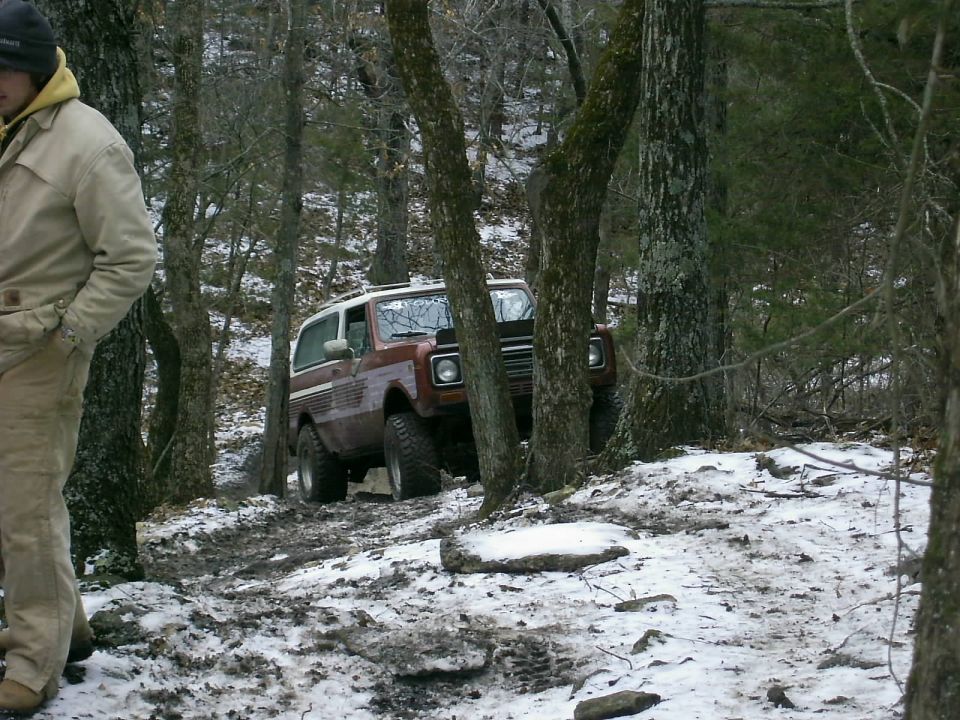 Brown SUV with white top on snowy trail, 1970s styling