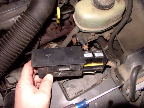 1990 Lincoln Town Car - Depress the tab on the end and the cover slides off to reveal three relays