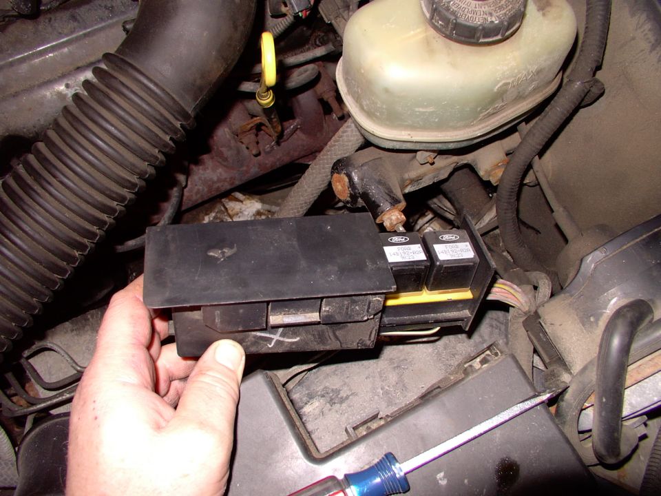 Depress the tab on the end and the cover slides off to reveal three relays