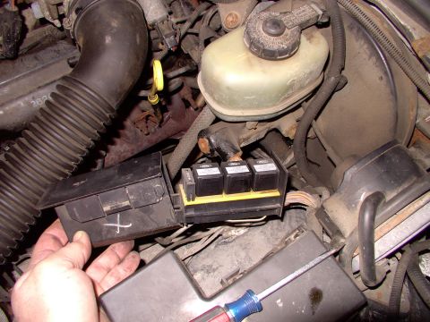 1990 Lincoln Town Car - Engine bay fuse box and relays, part of a vehicle's electrical system.