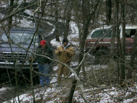 1978 Ford Bronco - Two men stand in a snowy wooded area next to a 1978 Ford Bronco and another SUV.