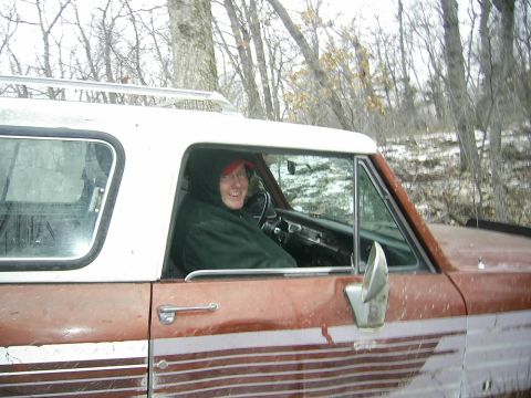 1978 Ford Bronco - A person sits in the driver's seat of a weathered SUV, ready for an outdoor adventure.