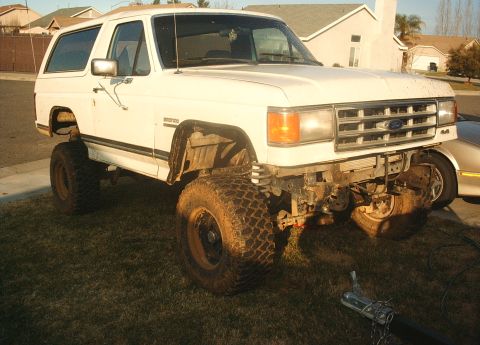 1987 Ford Bronco - This 1987 Ford Bronco features a lifted suspension and large off-road tires, ready for adventure.