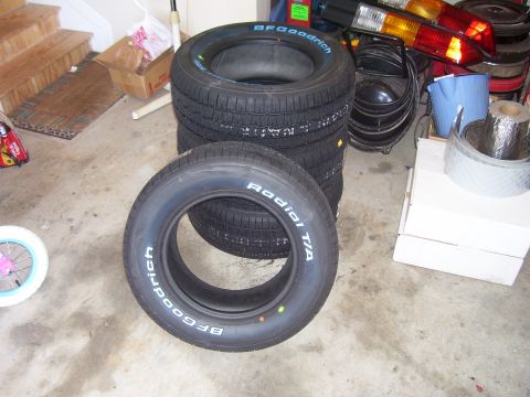 1979 Chevrolet Camaro - Several BFGoodrich Radial T/A tires are stacked in a garage, with other items in the background.