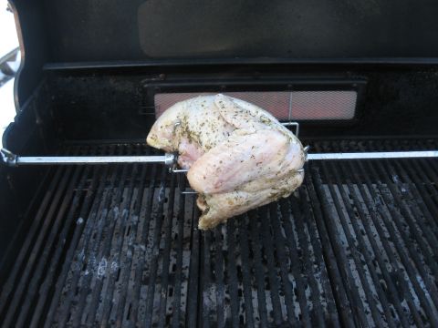 1996 Ford Bronco - A seasoned chicken is prepared for rotisserie cooking on a barbecue grill.