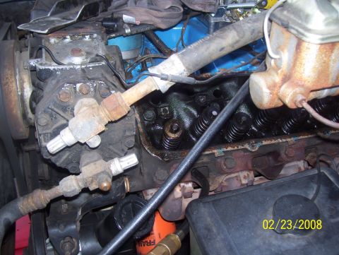 1978 Ford Bronco - Close-up view of an engine compartment showing various components and hoses.