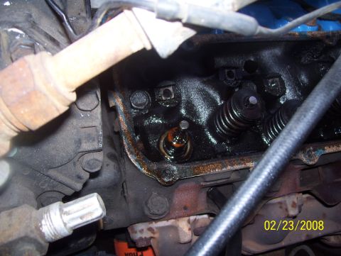 1978 Ford Bronco - Close-up view of an engine's valve train, showing mechanical components and oil buildup.