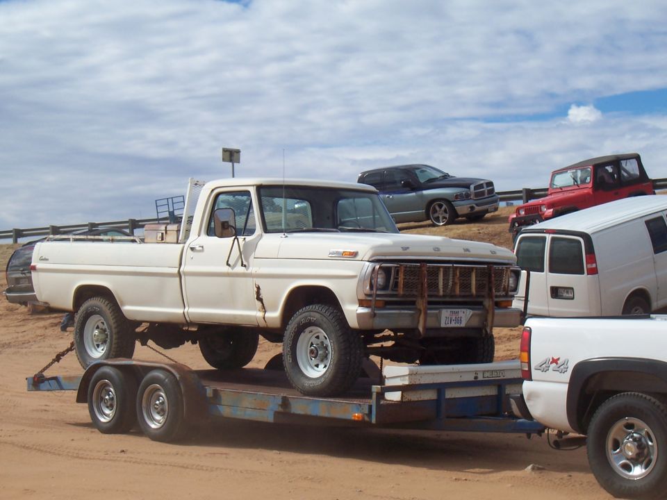 White 1970s pickup truck on trailer, front grille, Texas license plate