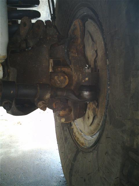 1994 Ford Bronco - Close-up view of the steering linkage and wheel hub assembly.