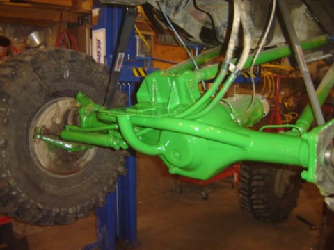 1992 Ford Bronco - Close-up of a freshly painted green rear axle assembly, likely undergoing restoration.