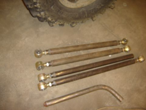 1992 Ford Bronco - Close-up of suspension components and a tire, with a watermark indicating 'SUPERMOTORS'.