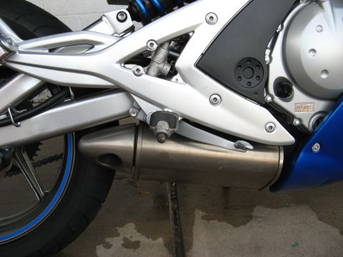 2007 Kawasaki Ninja - Close-up view of a motorcycle's exhaust system and frame components.