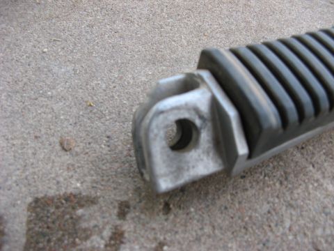 2007 Kawasaki Ninja - Motorcycle foot peg shown on a concrete surface.