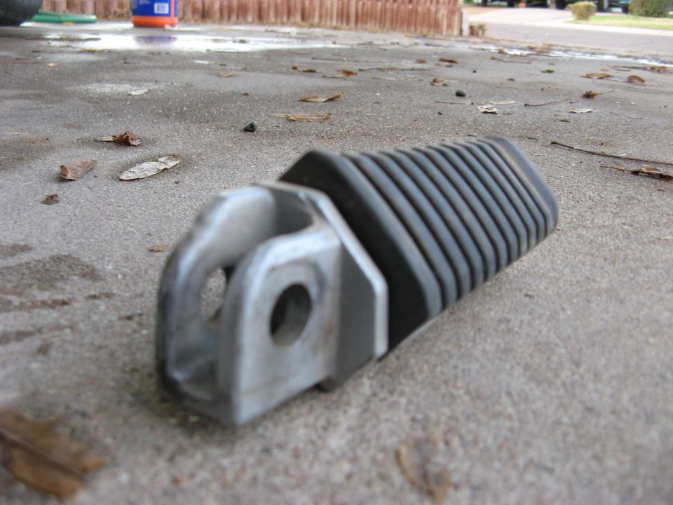 motorcycle foot peg on concrete ground