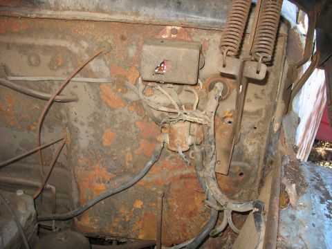 1952 Ford Panel Van - Close-up view of corroded engine bay components, including wiring and springs.
