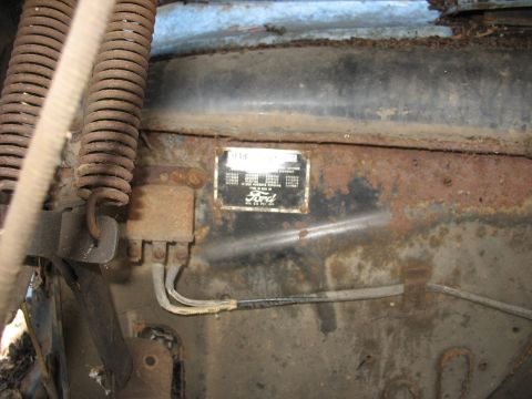 1952 Ford Panel Van - A close-up view of a Ford vehicle identification plate, showing various details and the Ford logo.