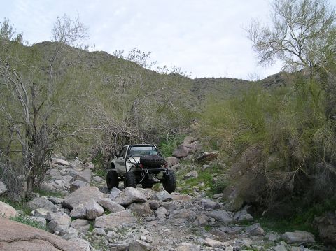 1986 Toyota Hilux - Modified 1986 Toyota Hilux navigates a rocky, off-road trail.