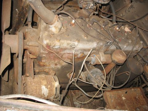 1952 Ford Panel Van - Close-up of a corroded V8 engine, likely from a mid-20th century vehicle.